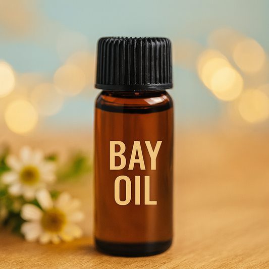  Amber glass Bay Oil bottle centered on wood with black cap and cream label. Golden bokeh and white chamomile flowers add a calming, holistic touch.