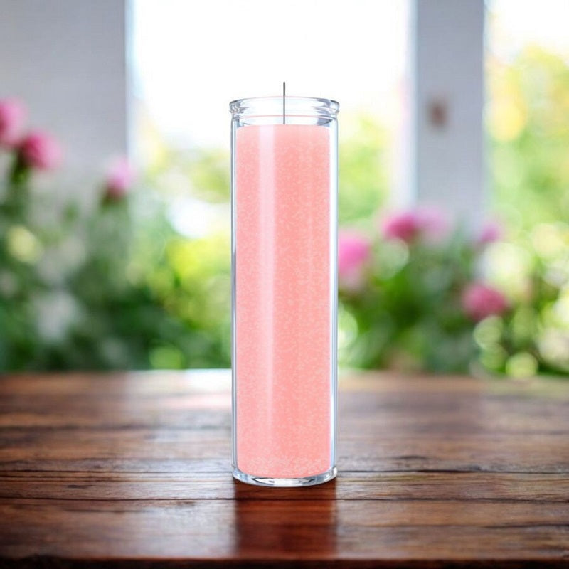 Unscented 7-day pink ritual candle in glass jar on wood table. Soft garden background with pink flowers. Used for love and healing.