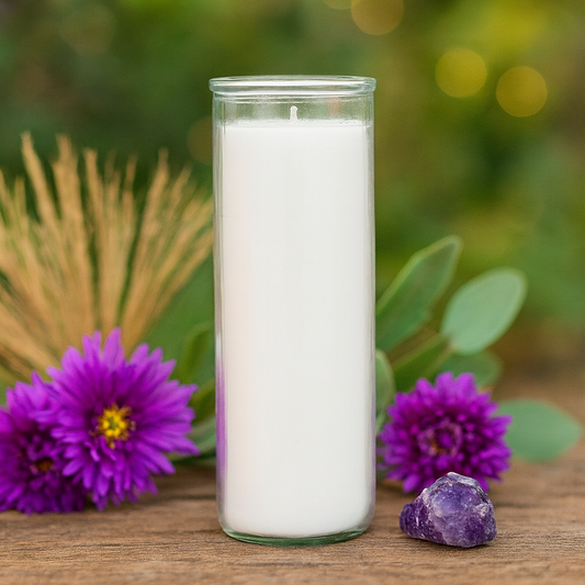 White 7-day ritual candle on wood, surrounded by purple flowers, green foliage, and amethyst stone. Conveys cleansing and protection. 